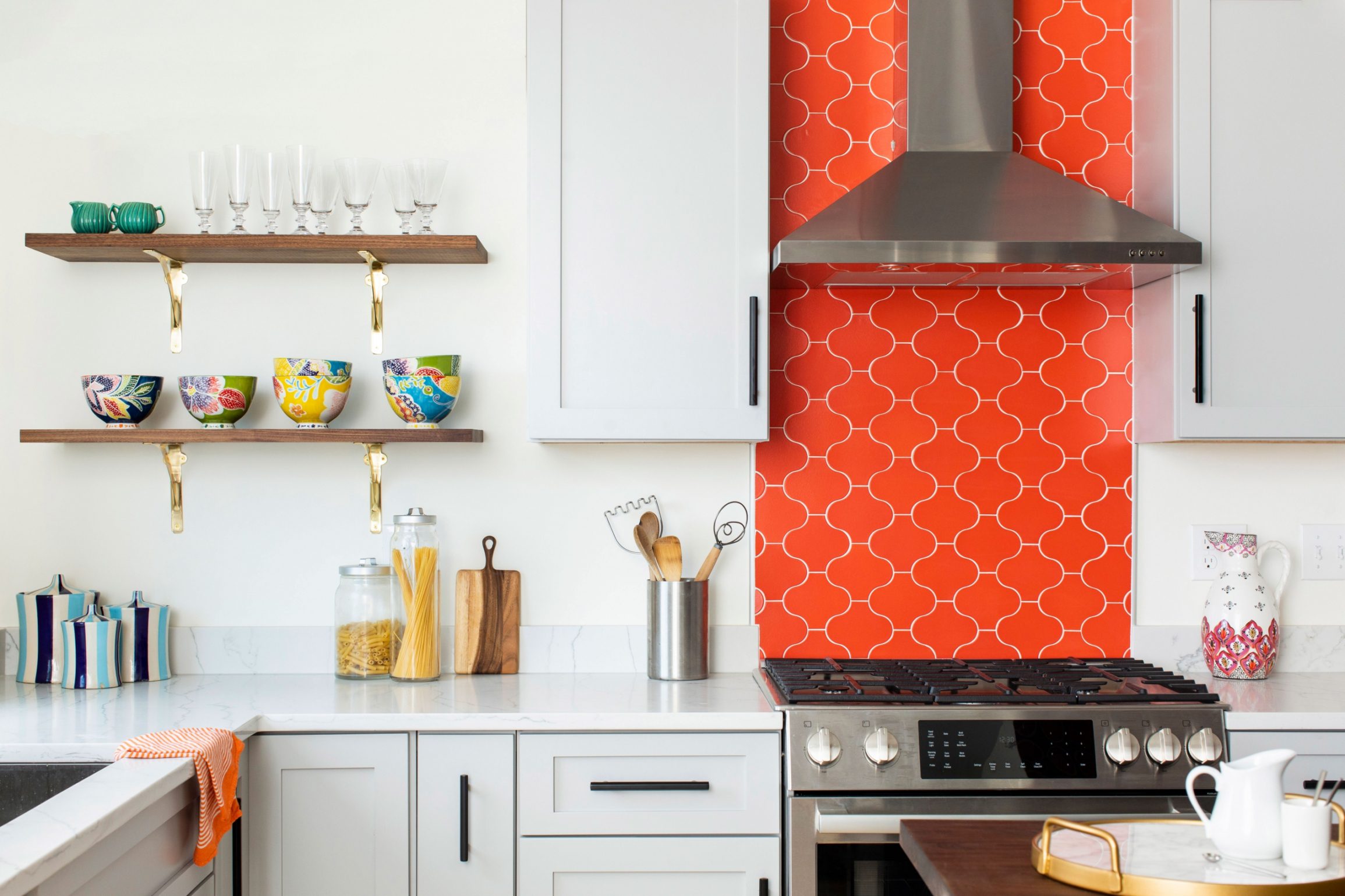 Orange tile backsplash and open shelving