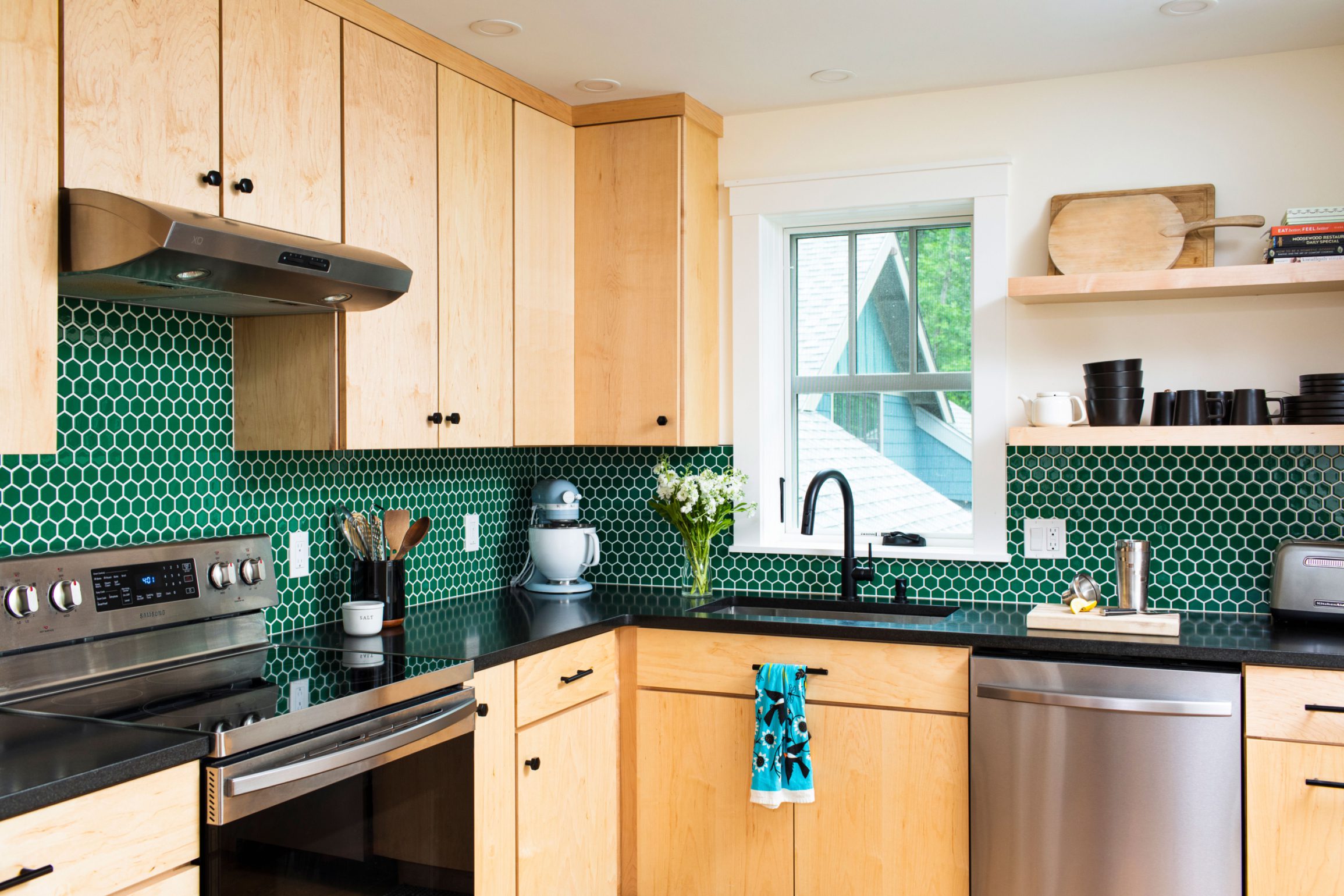 Green tiled kitchen with maple cabinets