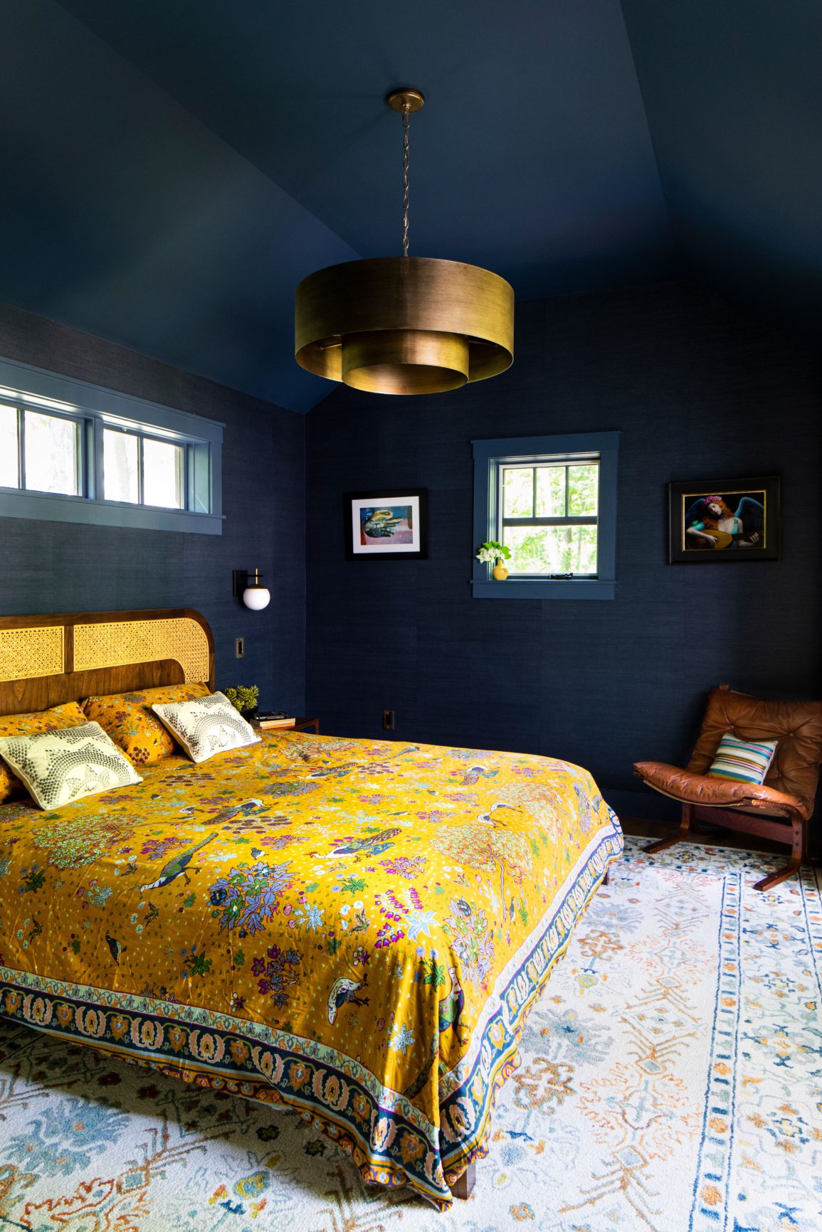 Dark blue bedroom with yellow bedspread
