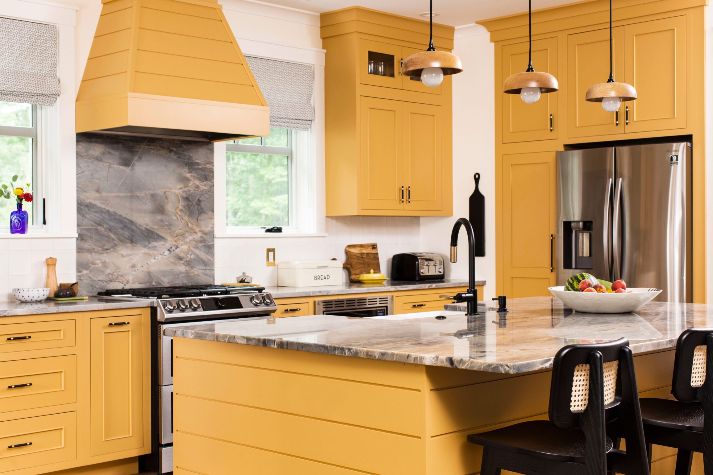 Yellow kitchen island with granite countertop